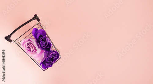 Top view Roses bouquet in shopping cart. Flowers delivery. 8 march. Mother's day. Valentine's present. Copy space