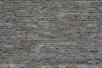 Big brick stone wall with small and uneven background, space for text, no people and horizontal