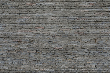 Grey brick wall with small stones, empty wall with space for text, no person