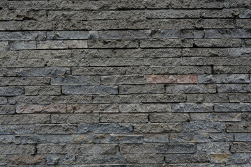 Gray brick wall with uneven and rustic surface, space for text, background as template, no person