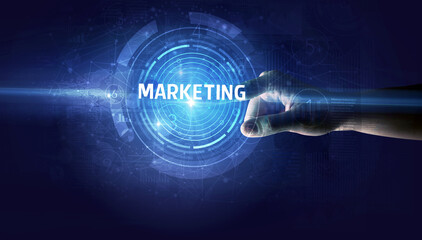 Hand touching MARKETING button, modern business technology concept