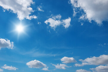 Blue sky with clouds and sun.