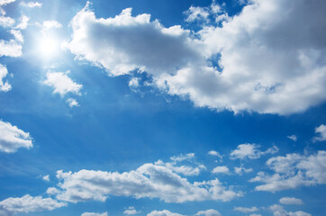 Blue sky with clouds and sun.