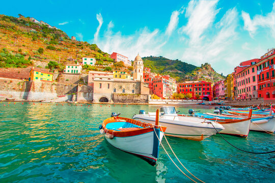 Fishing boat in Vernazza - Cinque Terre on the mountain near mediterranean sea in liguria - Italy. Sunny cloudy sky. Traditional italian architecture