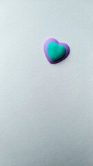 two hearts of turquoise and violet colors of a light textured background