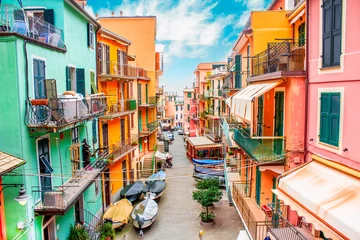 Fotobehang Liguria Manarola, Liguria Italy. Traditional typical Italian village in National park Cinque Terre, colorful multicolored buildings houses, fishing boats on road, blue cloudy sky