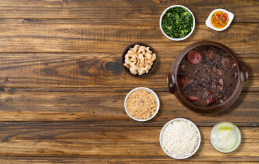 Traditional brazilian feijoada with rice, kale, caipirinha, cracklings, manioc flour and copy space