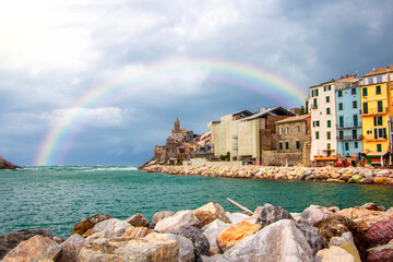 Rainbow on Portovenere (Porto Venere) in Liguria, Italy: scenic view of the Church of St. Peter...