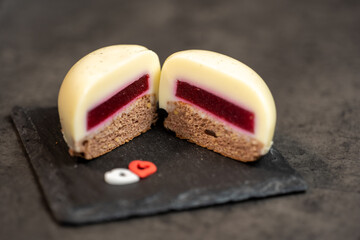vanilla moose cake cut in half in the shape of a heart on ardesia