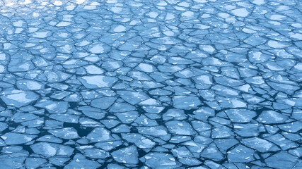 Large chunks of ice blocks forming a beautiful pattern, after the icebreaker ship passed by and...