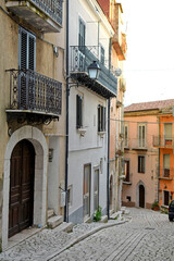 A narrow street between the old houses of Guardia Sanframondi, a medieval village in the province of Salerno, Italy.