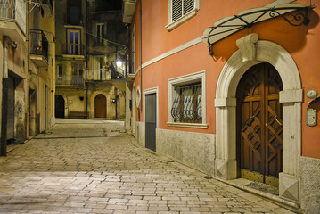 A narrow street between the old houses of Guardia Sanframondi, a medieval village in the province of Salerno, Italy.