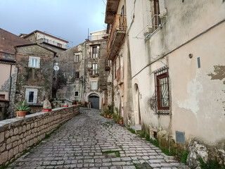 Fototapeta na wymiar A narrow street between the old houses of Guardia Sanframondi, a medieval village in the province of Salerno, Italy.