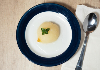 Fresh half Pears Served with sweet syrup and mint. Black, wooden, Blue background.