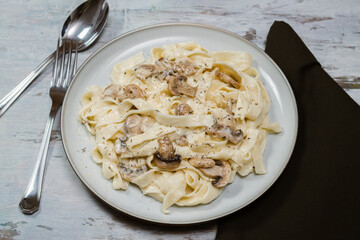 Fancy organic fetuccine pasta with creamy alfredo mushroom sauce