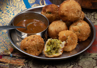 Indian potato bonda snack with tamarind chutney