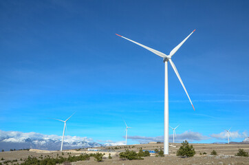 Wind farm on the mountain. Wind turbines on the hill. Renewable energy. Wind park.
