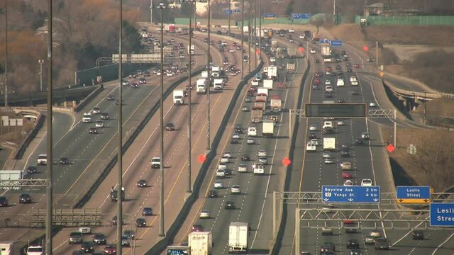 Highway. Heavy volume on multi-lane freeway with heatshimmer. Summer traffic on HWY 401 in Toronto, Ontario, Canada.