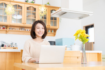 部屋でラップトップコンピューターを見る女性