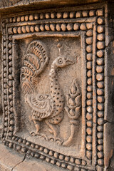 Myanmar, Bagan. Historic Archaeological Zone near Le-myet-hna temple area. Temple detail, stone carved peacock.