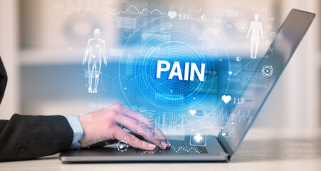 Doctor working a health check with PAIN inscription, recording medical test results