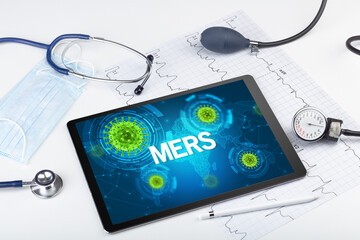 Close-up view of a tablet pc with MERS inscription, microbiology concept