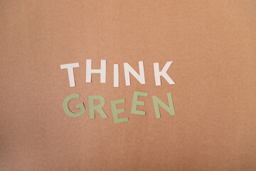 Think green cardboard letters on a craft paper