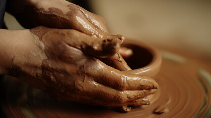 Woman hands sculpting clay product in workshop. Lady modeling pot in studio