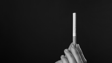 cigarette in hand in monochrome,smoking copy space