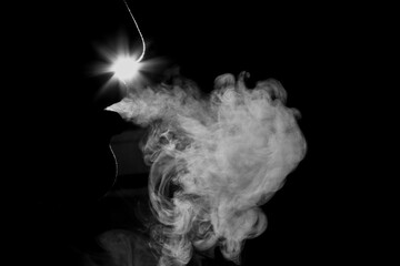 Smoke electronic cigarette on dark background