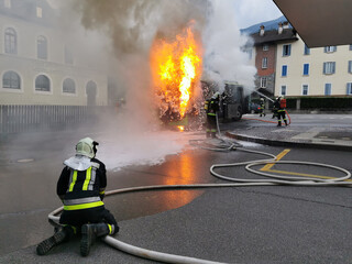 A large fire starts in the back of a bus just before it leaves the public station in the city...