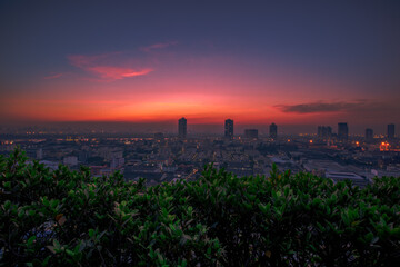 The blurred abstract background of the morning sun exposure to the tiny dust particles that surround the tall buildings in the capital, the long-term health issue of pollution.
