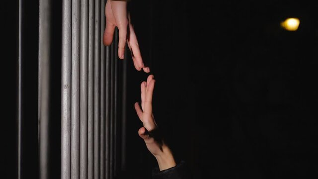 symbol of distance - hand of man and woman reach out without touching