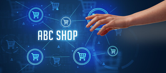 Close-Up of cropped hand pointing at ABC SHOP inscription, online shopping concept