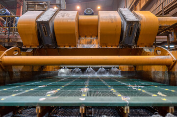 Vibrating screen, ore washing with liquid. The liquid is poured out in a fan-like stream from...