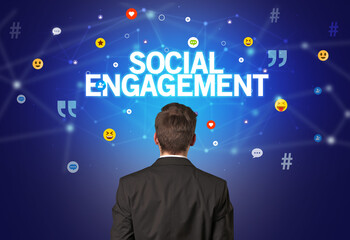 Rear view of a businessman with SOCIAL ENGAGEMENT inscription, social networking concept