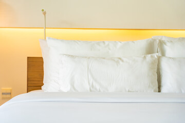 Fototapeta na wymiar White pillow on bed decoration interior of bedroom