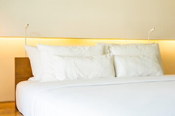 Fototapeta na wymiar White pillow on bed decoration interior of bedroom