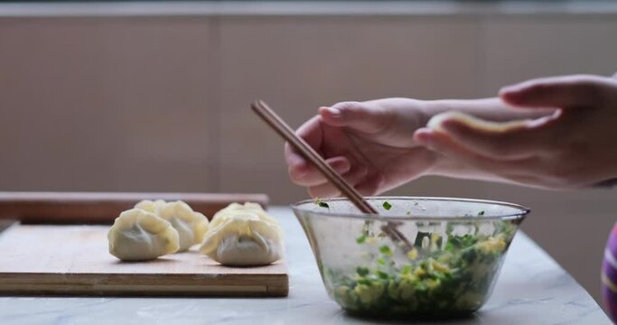 close up hand making dumpling. Traditional Chinese food during Chinese new year. Chinese culture concept