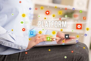 Close up of business person playing multimedia with social media icons and PLATFORM inscription