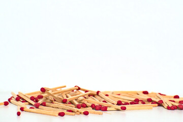 a lot of red matches piled up on a white table