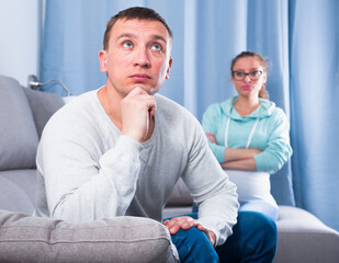 Husband and pregnant wife having disagreement with each other at home