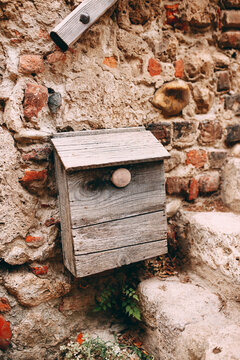 Old wooden post box on stone wall in Perouges, France