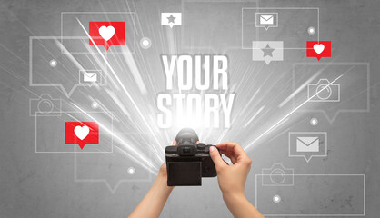 Close-up of a hand taking photos with YOUR STORY inscription, social media concept