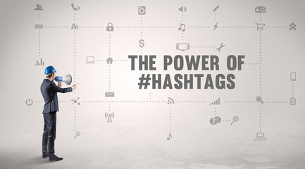 Engineer working on a new social media platform with THE POWER OF #HASHTAGS inscription concept
