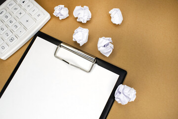 On a yellow background is a stationery tablet with a white blank sheet and a white calculator....