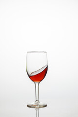 Glass of sweet red wine on white background.