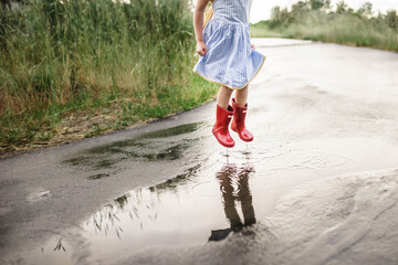 child walking in the rain