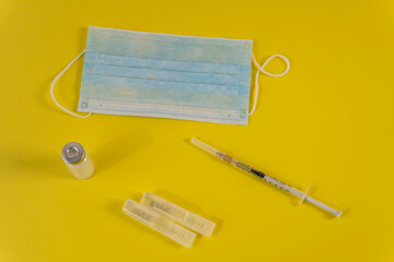 Flat Lay for medical theme and vaccinations from COVID-19. Medicine, vaccine, syringe, mask.