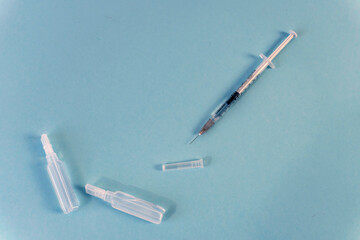 Flat Lay for medical theme and vaccinations from COVID-19. Medicine, vaccine, syringe, mask.